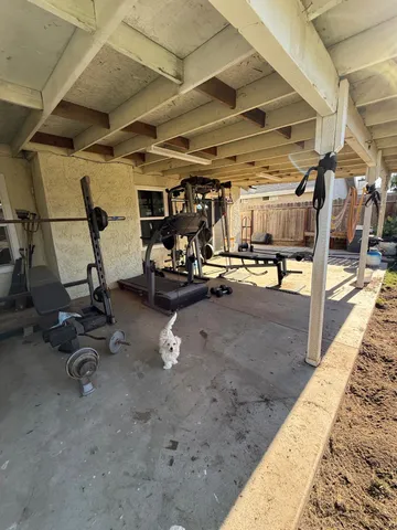 a view of a yard with wooden fence