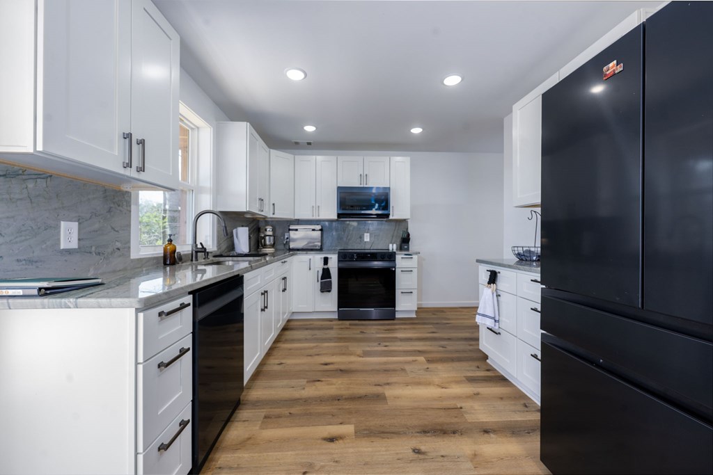 3160 Morrow Road Murphy, NC 28906 - Photo 23 of 44 a kitchen with granite countertop a stove top oven and cabinets