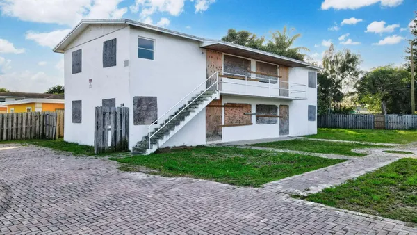 a view of a yard in front view of a house