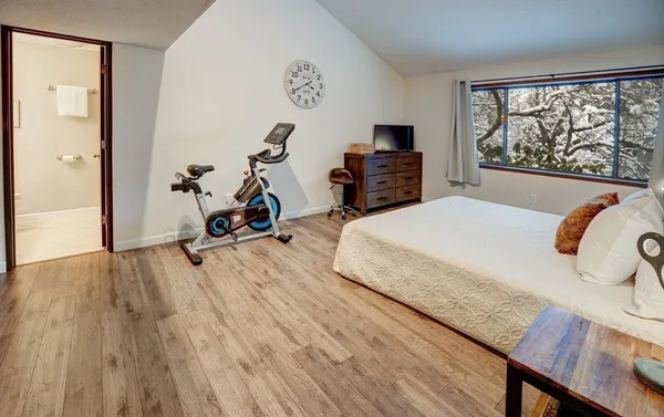 a bedroom with a bed and a desk