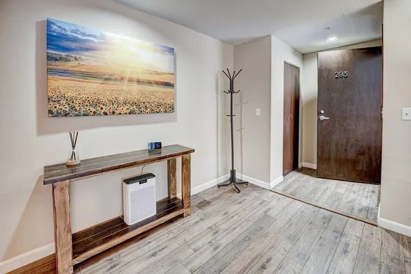 a view of an entryway with wooden floor