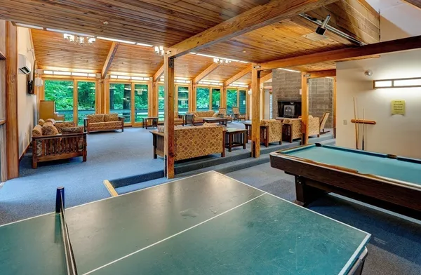 a room with pool table and windows