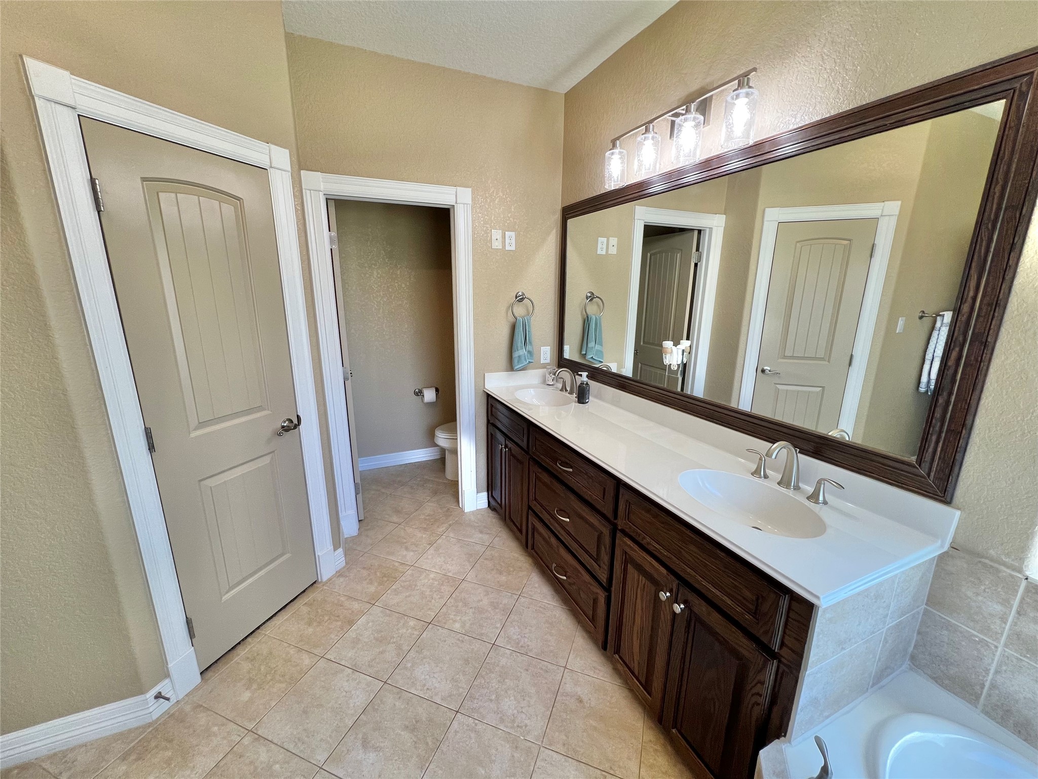 4916 County Road 819 Brazoria, TX 77422 - Photo 22 of 49 a spacious bathroom with a double vanity sink a and mirror