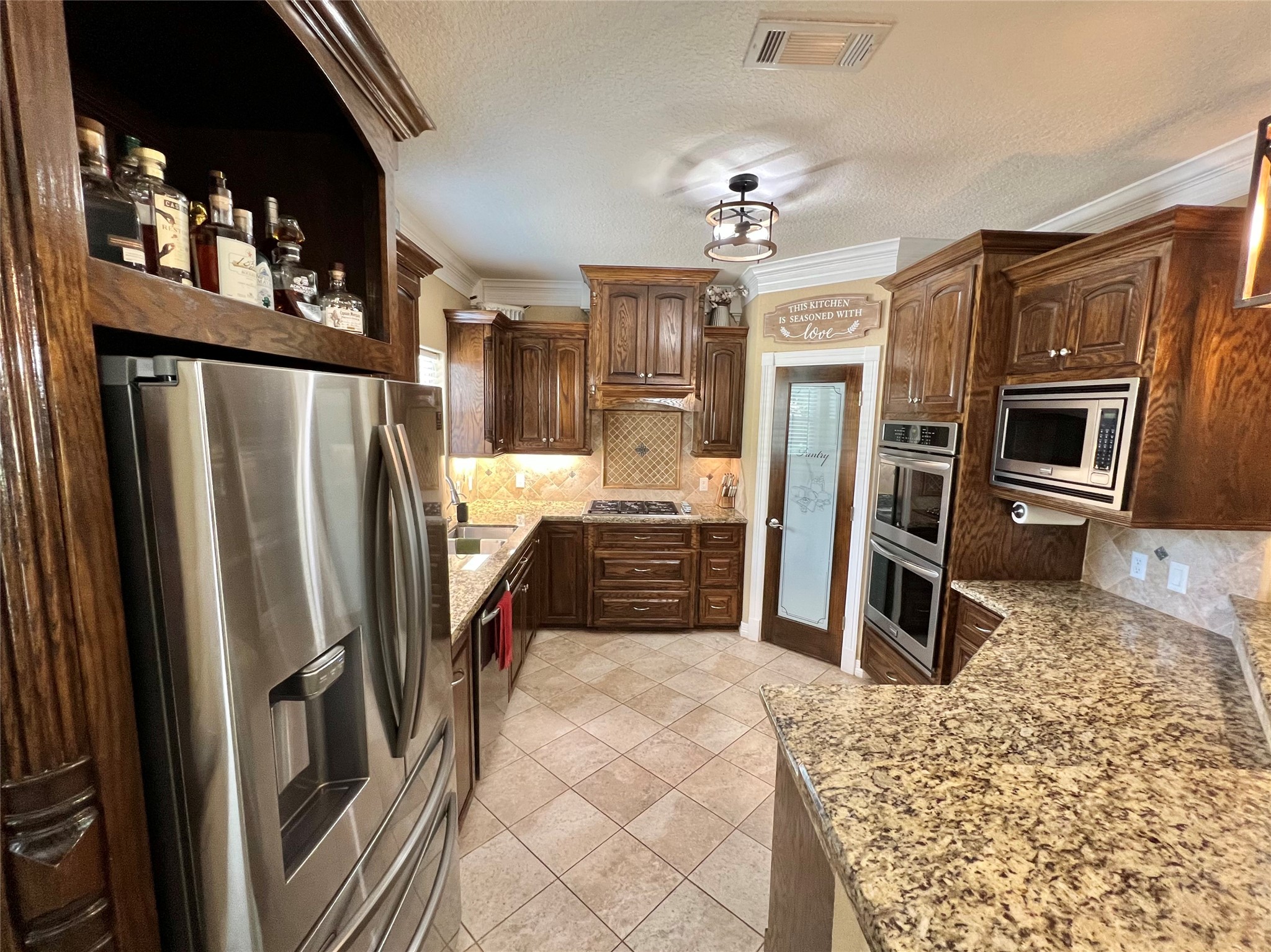 4916 County Road 819 Brazoria, TX 77422 - Photo 6 of 49 a kitchen with stainless steel appliances granite countertop a refrigerator a stove and a sink