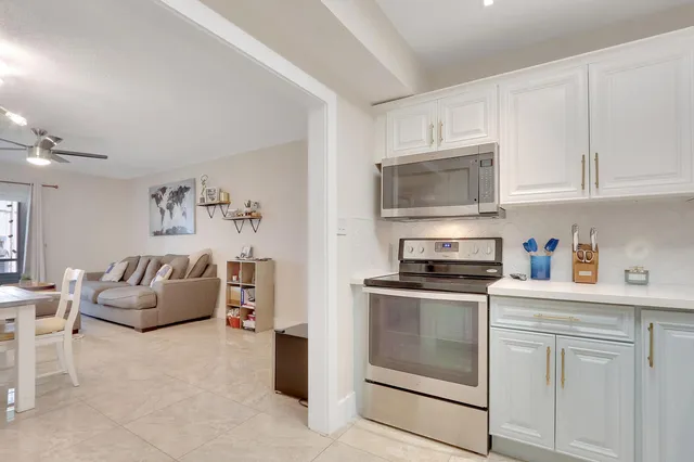 a kitchen with cabinets stainless steel appliances and a counter space