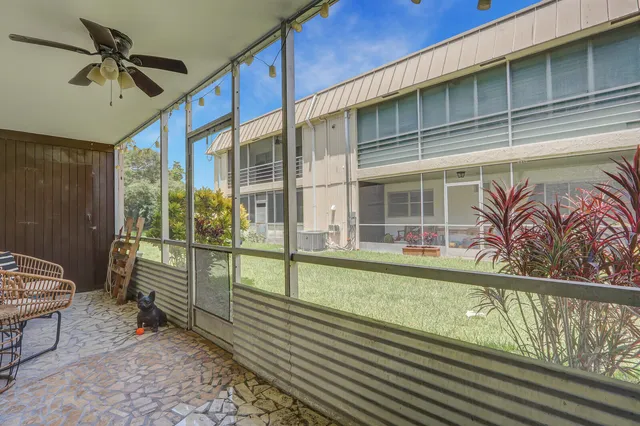 a view of a porch with furniture and front door