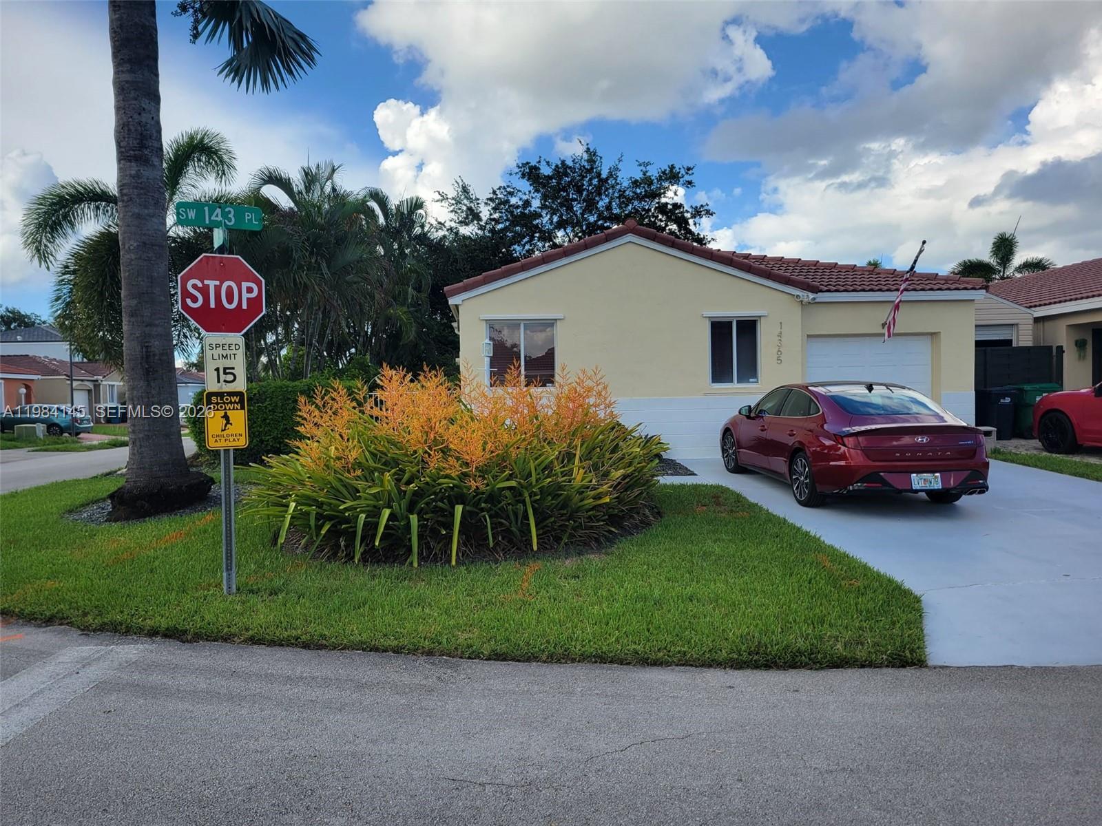 a view of a house with a yard and a garage