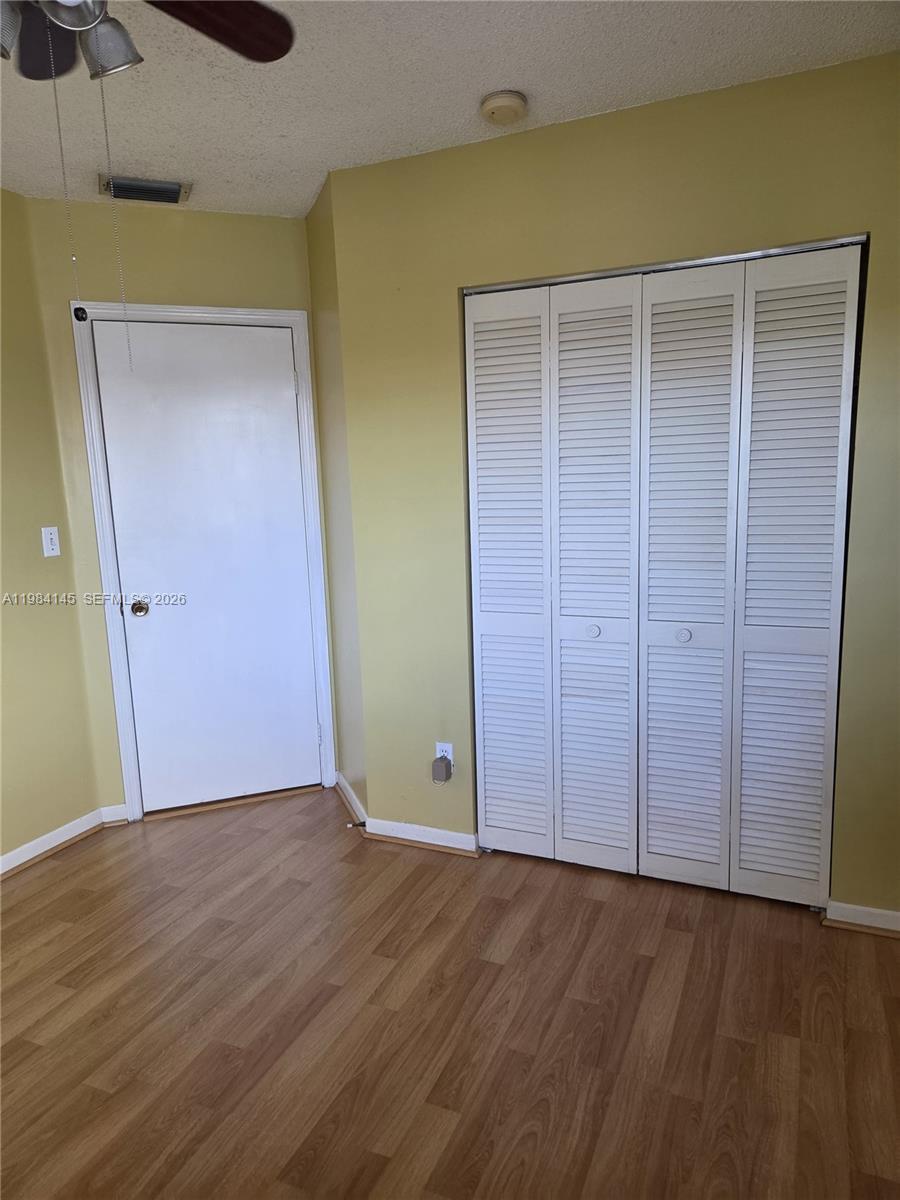 14365 Southwest 175th Terrace Miami, FL 33177 - Photo 11 of 31 an empty room with wooden floor and closet