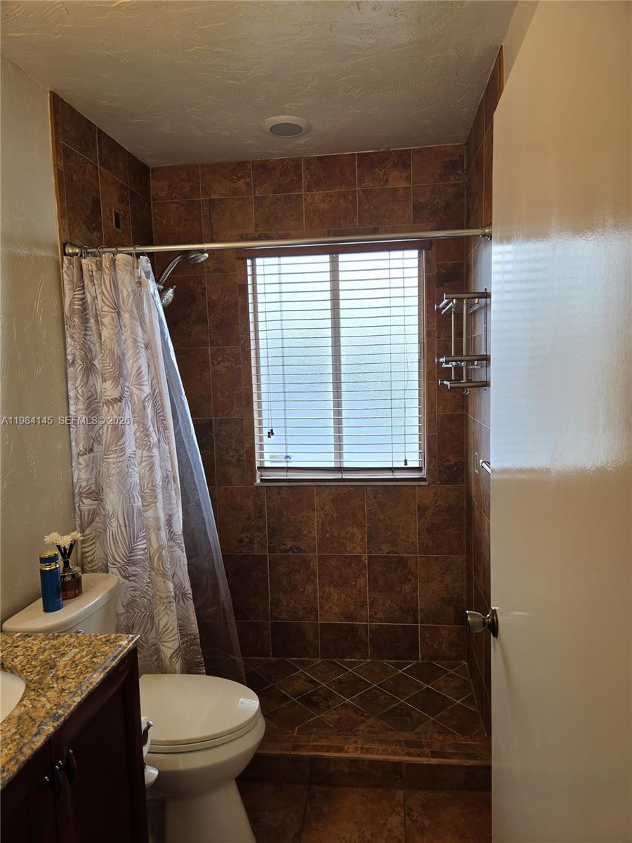 14365 Southwest 175th Terrace Miami, FL 33177 - Photo 12 of 31 a bathroom with a granite countertop sink toilet and shower