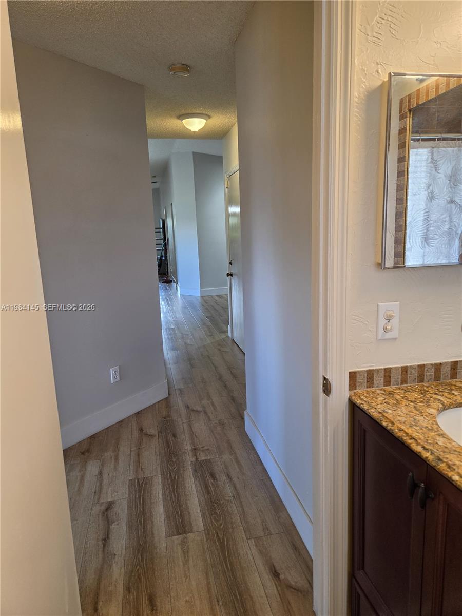 14365 Southwest 175th Terrace Miami, FL 33177 - Photo 14 of 31 a view of hallway with wooden floor
