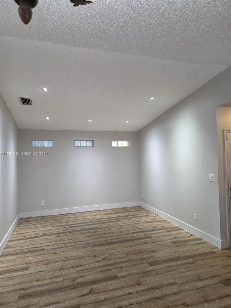 14365 Southwest 175th Terrace Miami, FL 33177 - Photo 16 of 31 a view of an empty room with wooden floor