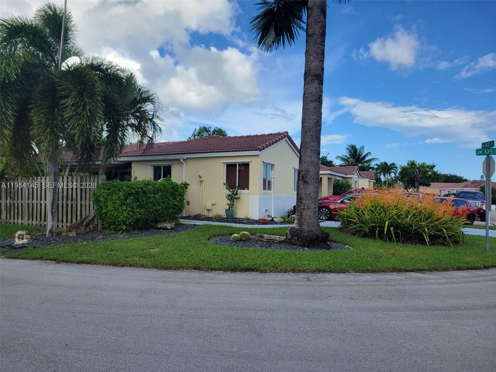14365 Southwest 175th Terrace Miami, FL 33177 - Photo 2 of 31 a view of a white house with a big yard and potted plants