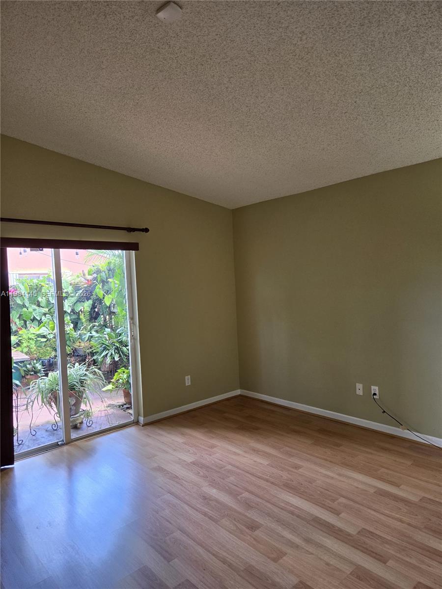 14365 Southwest 175th Terrace Miami, FL 33177 - Photo 26 of 31 an empty room with wooden floor and windows