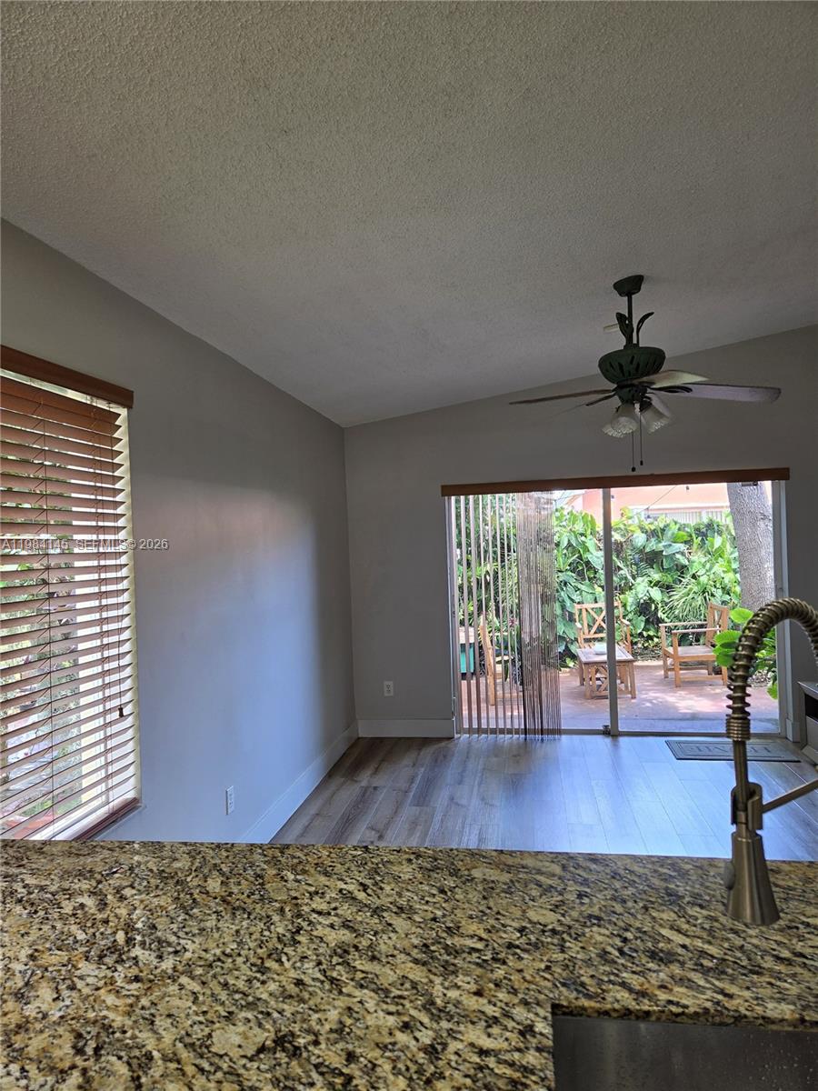 14365 Southwest 175th Terrace Miami, FL 33177 - Photo 27 of 31 a view of empty room with wooden floor and fan