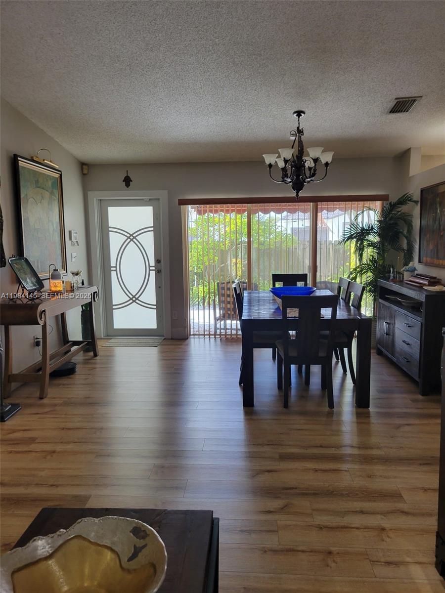 14365 Southwest 175th Terrace Miami, FL 33177 - Photo 5 of 31 a view of a dining room with furniture window and wooden floor