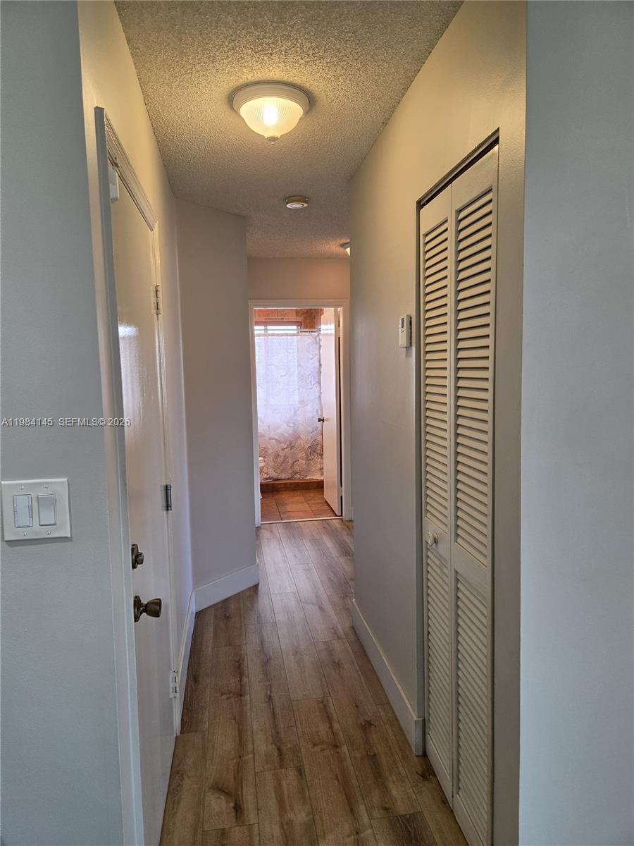14365 Southwest 175th Terrace Miami, FL 33177 - Photo 7 of 31 a view of a hallway with wooden floor