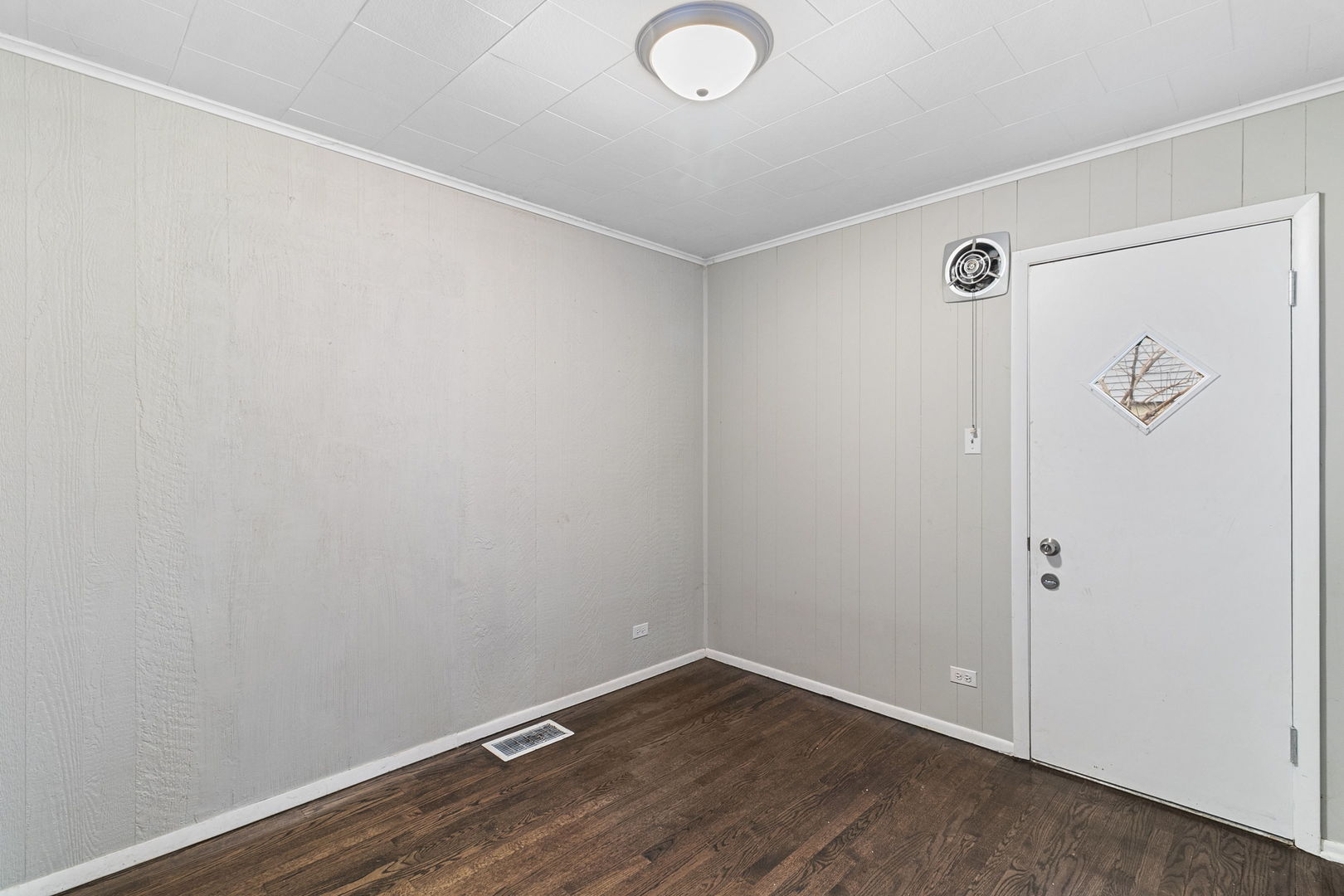 6837 Roberts Road Bridgeview, IL 60455 - Photo 12 of 22 an empty room with wooden floor and windows