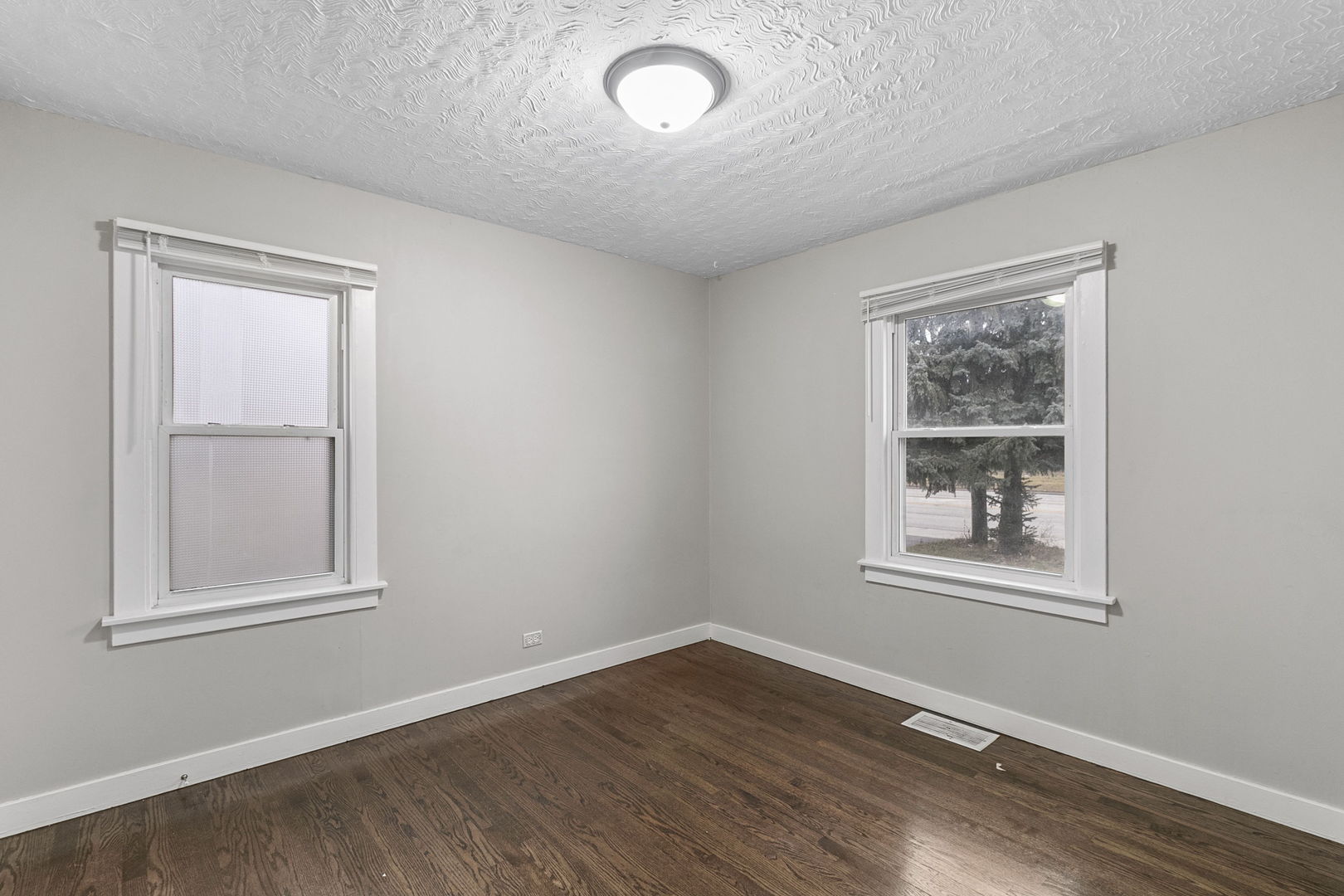6837 Roberts Road Bridgeview, IL 60455 - Photo 13 of 22 an empty room with wooden floor and windows