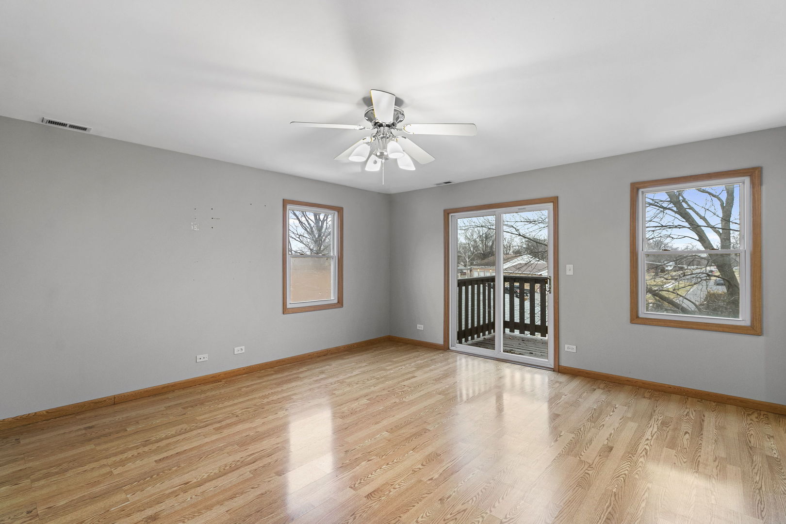 6837 Roberts Road Bridgeview, IL 60455 - Photo 14 of 22 a view of an empty room with window and wooden floor
