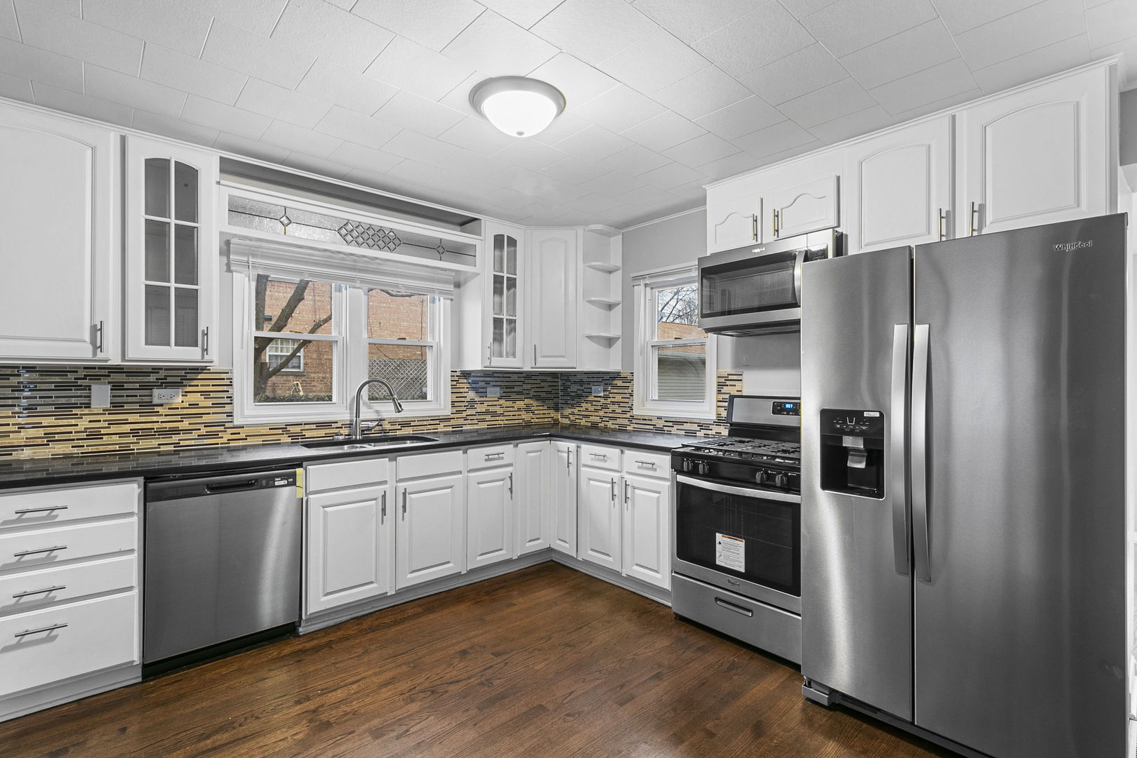6837 Roberts Road Bridgeview, IL 60455 - Photo 2 of 22 a kitchen with granite countertop stainless steel appliances and wooden cabinets