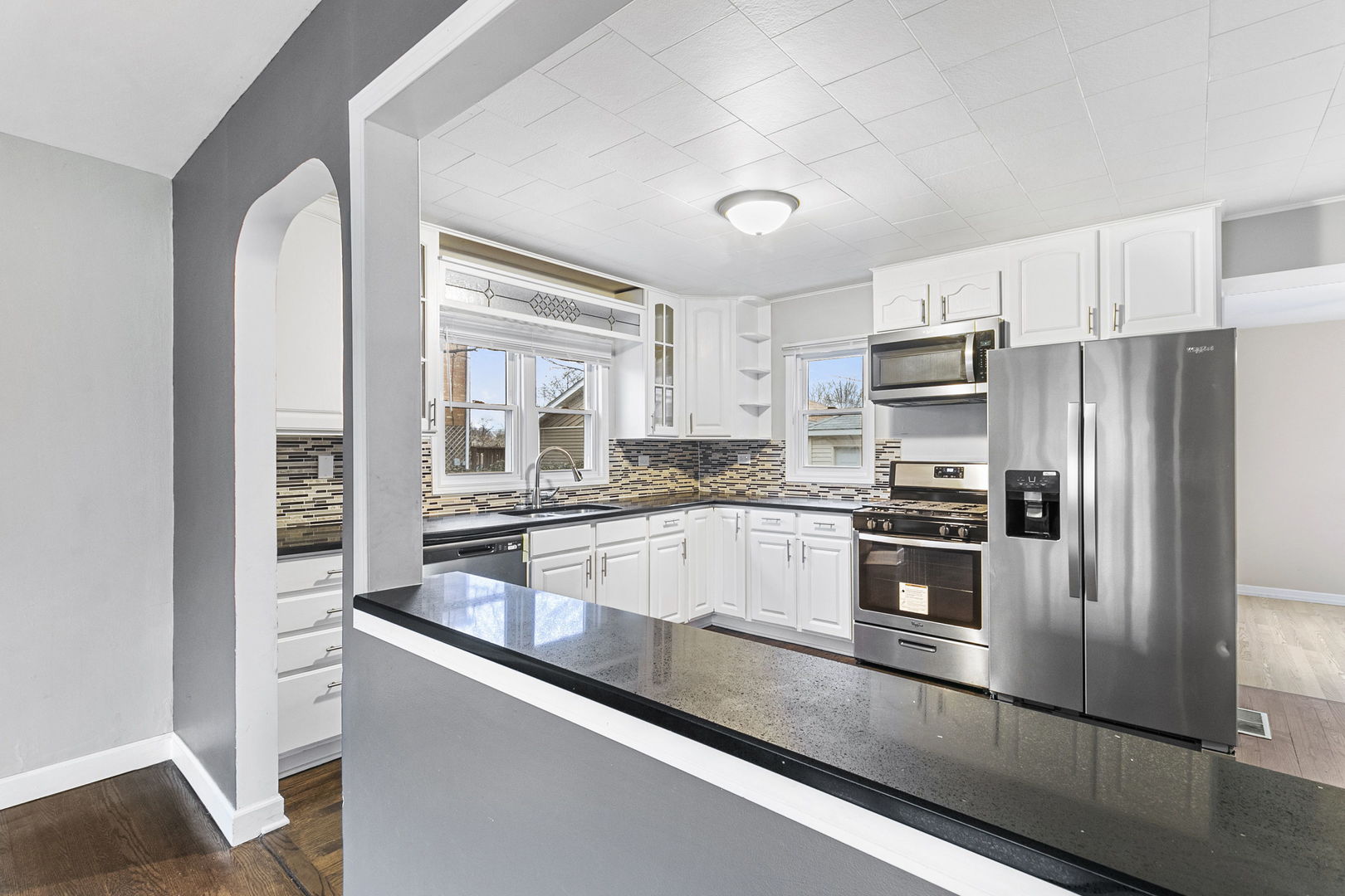 6837 Roberts Road Bridgeview, IL 60455 - Photo 4 of 22 a kitchen with granite countertop a refrigerator and a stove top oven