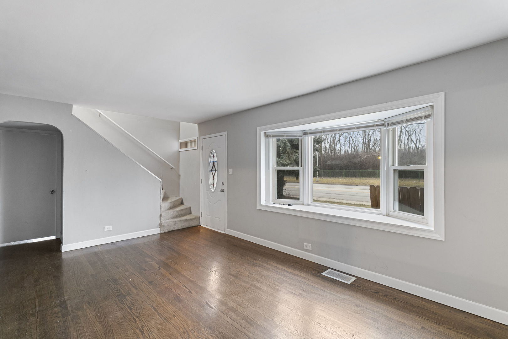 6837 Roberts Road Bridgeview, IL 60455 - Photo 5 of 22 a view of empty room with wooden floor and fan