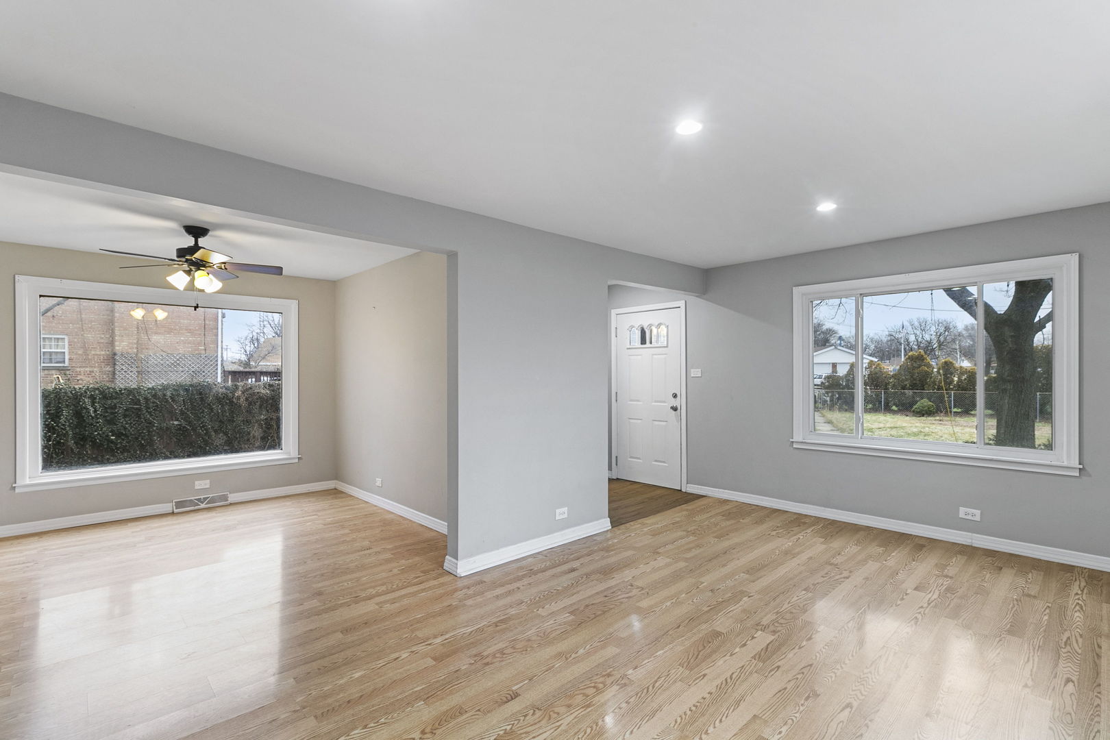 6837 Roberts Road Bridgeview, IL 60455 - Photo 6 of 22 an empty room with wooden floor and windows