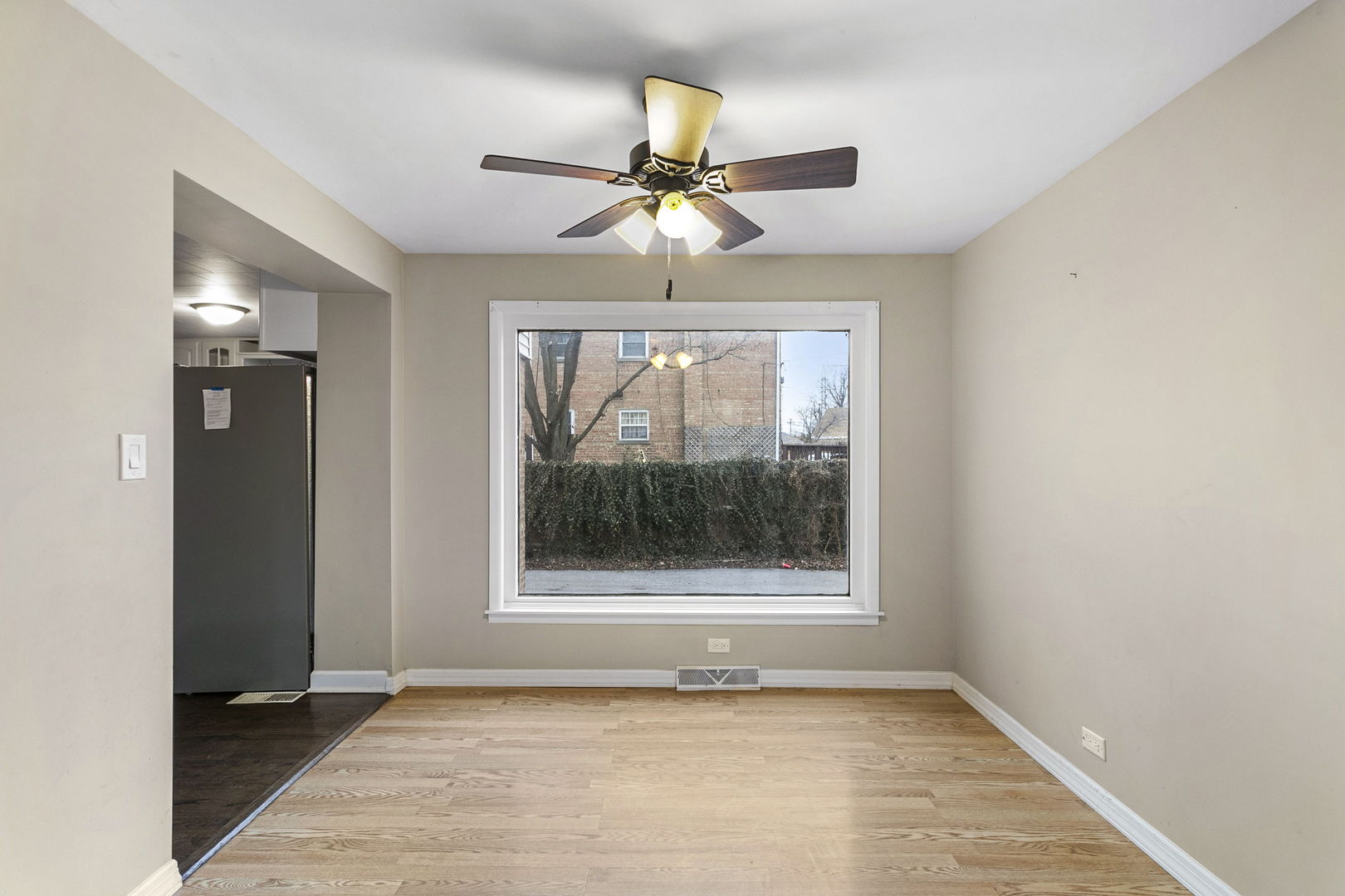 6837 Roberts Road Bridgeview, IL 60455 - Photo 7 of 22 an empty room with windows and fan