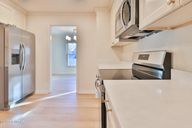 a view of living room with furniture and stainless steel appliances