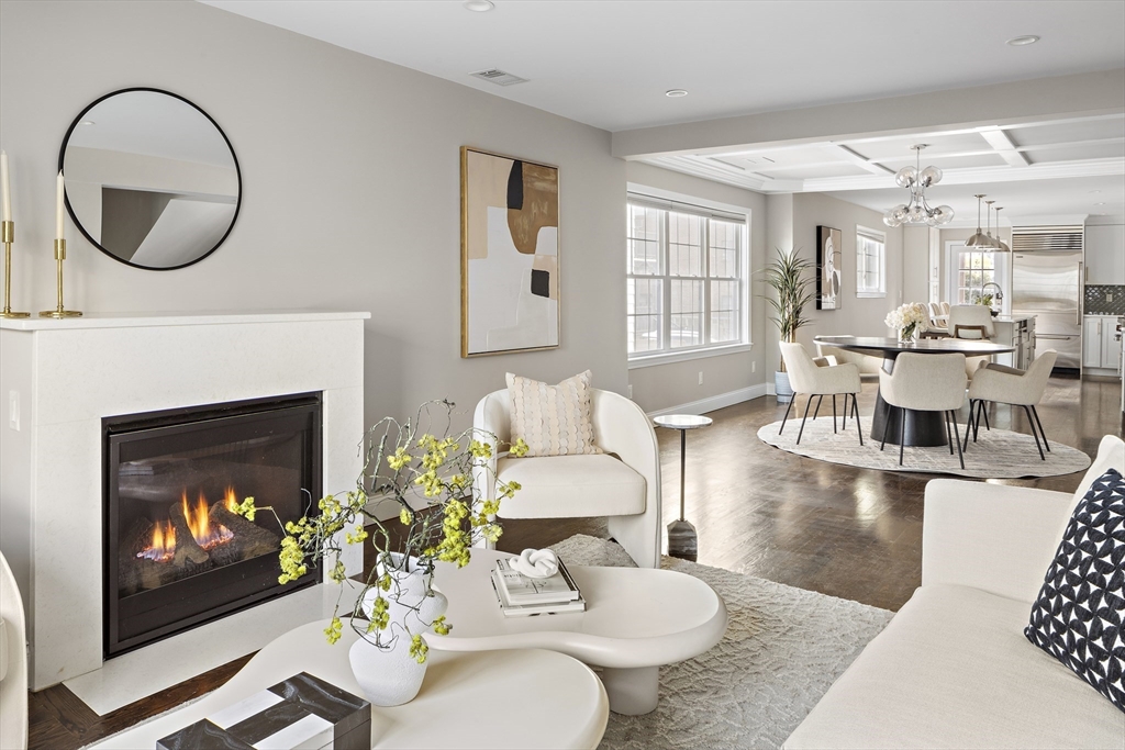 12 Madison Street, Unit 2 Somerville, MA 02143 - Photo 1 of 24 a living room with furniture a fireplace and a large window