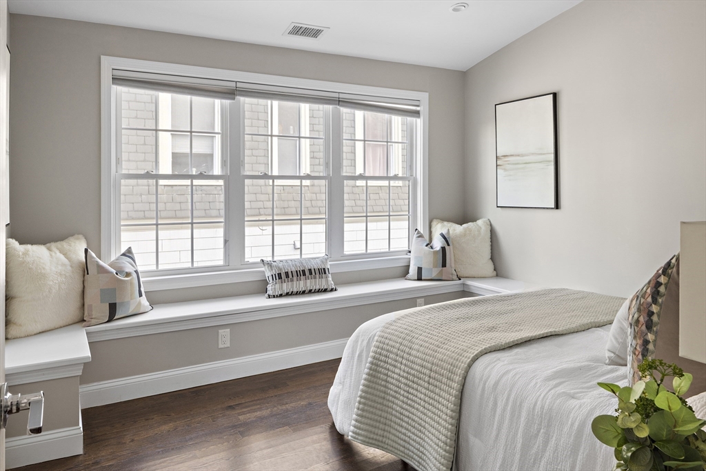 12 Madison Street, Unit 2 Somerville, MA 02143 - Photo 12 of 24 a spacious bedroom with a bed and a large window