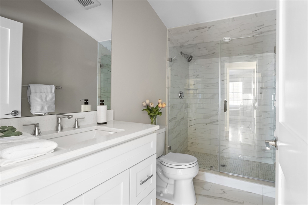 12 Madison Street, Unit 2 Somerville, MA 02143 - Photo 13 of 24 a bathroom with a sink a toilet and shower