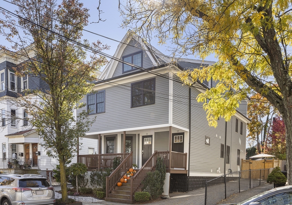 12 Madison Street, Unit 2 Somerville, MA 02143 - Photo 18 of 24 a front view of a house with a tree