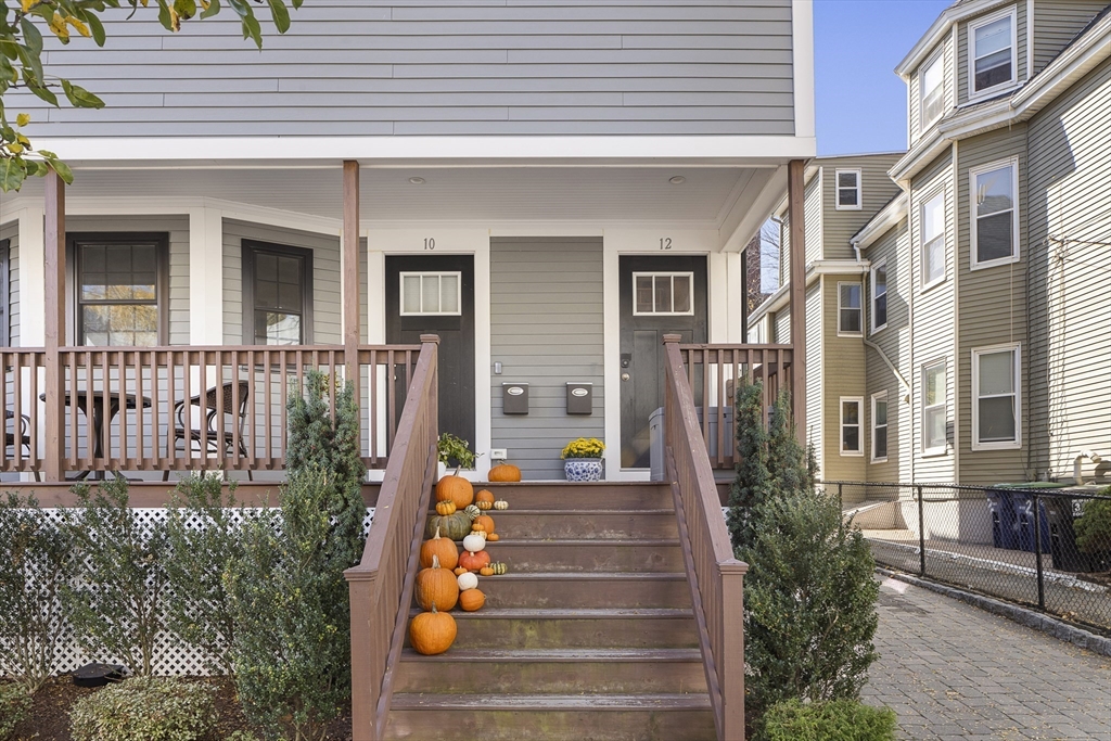 12 Madison Street, Unit 2 Somerville, MA 02143 - Photo 19 of 24 a front view of a house with a garden
