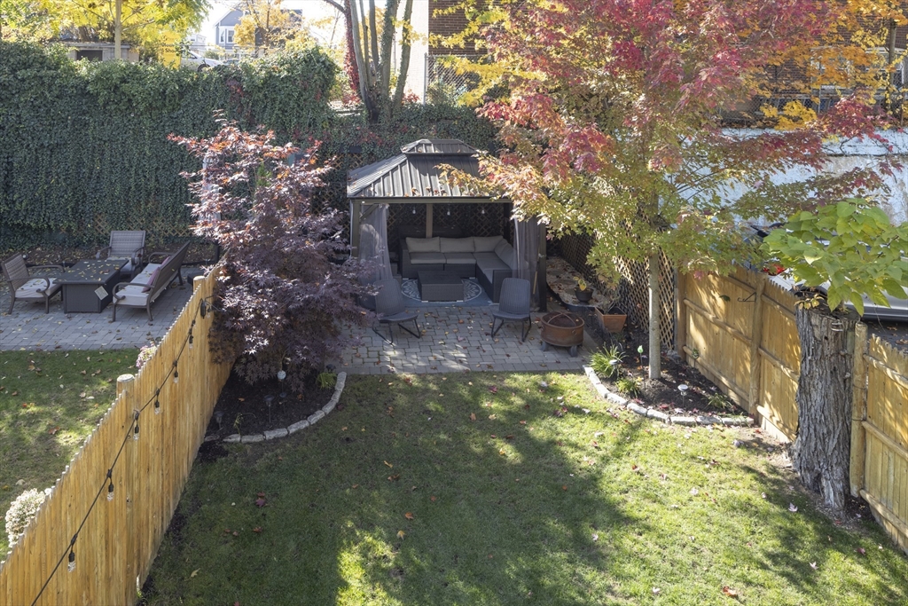12 Madison Street, Unit 2 Somerville, MA 02143 - Photo 20 of 24 a front view of a house with a yard