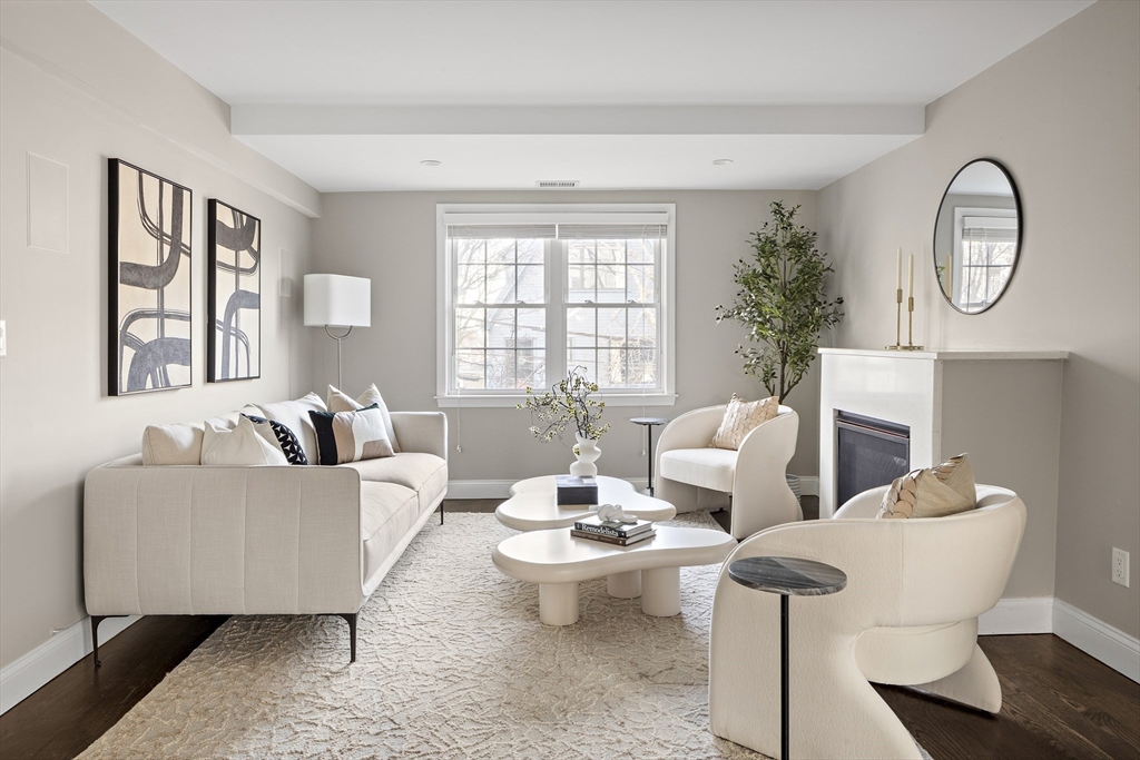12 Madison Street, Unit 2 Somerville, MA 02143 - Photo 2 of 24 a living room with furniture a table and a large window