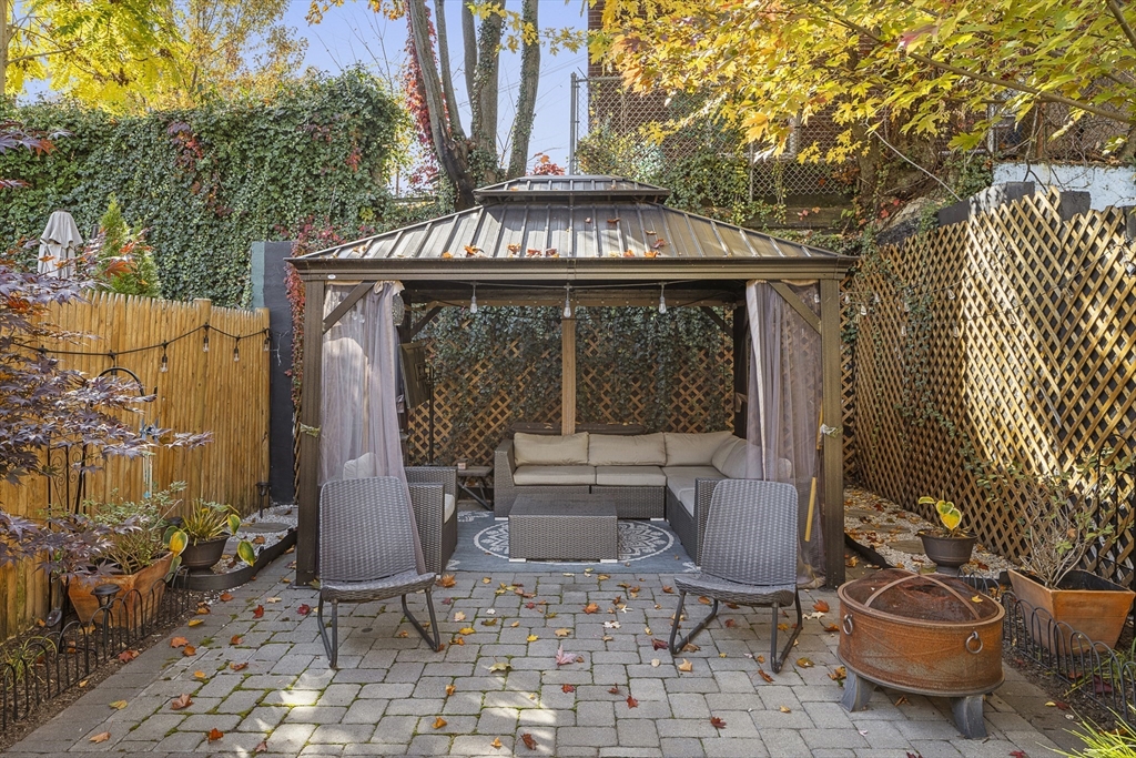 12 Madison Street, Unit 2 Somerville, MA 02143 - Photo 21 of 24 a view of a patio with table and chairs and potted plants