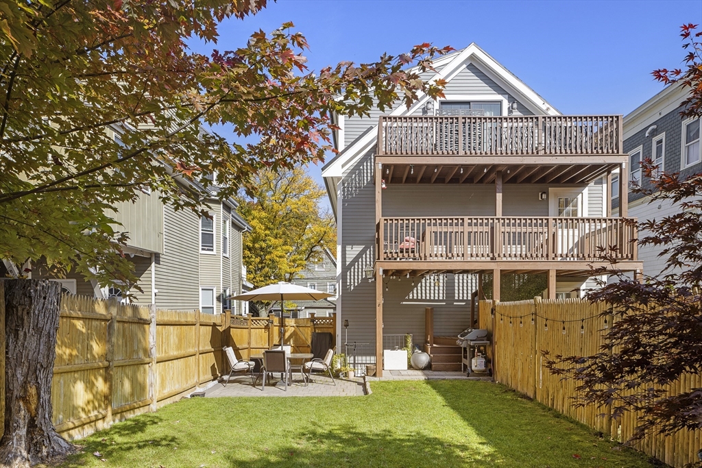 12 Madison Street, Unit 2 Somerville, MA 02143 - Photo 23 of 24 a front view of a house with a yard