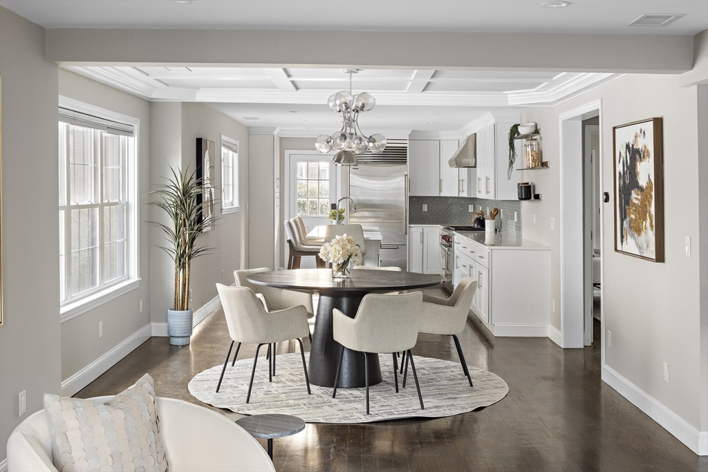 12 Madison Street, Unit 2 Somerville, MA 02143 - Photo 3 of 24 a dining room with wooden floor and large windows