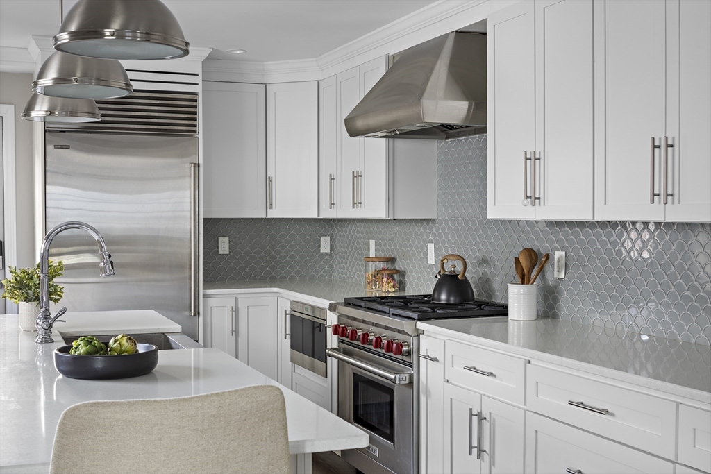 12 Madison Street, Unit 2 Somerville, MA 02143 - Photo 5 of 24 a kitchen with stainless steel appliances granite countertop a sink and cabinets