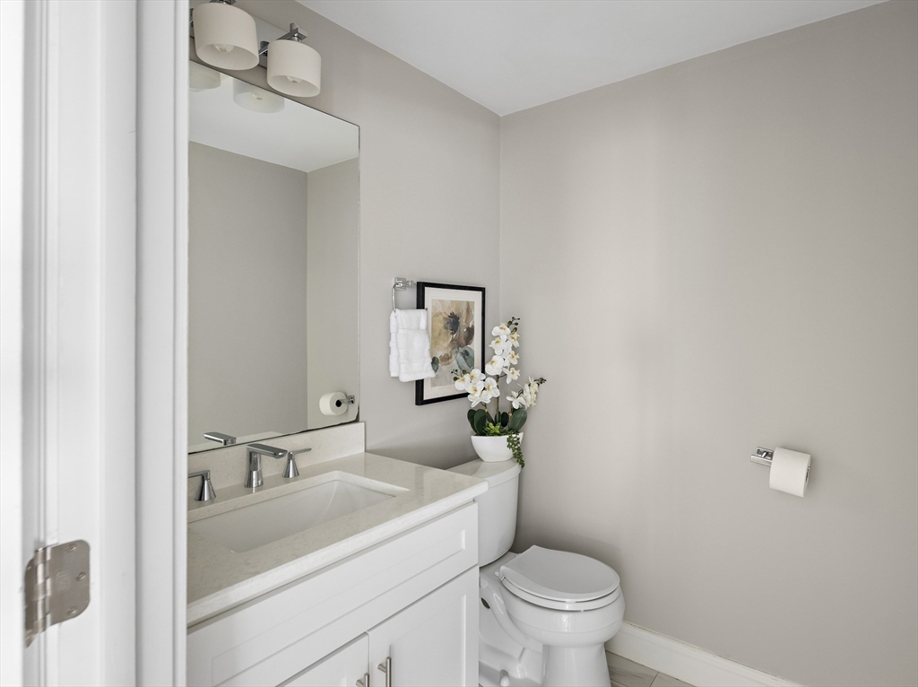 12 Madison Street, Unit 2 Somerville, MA 02143 - Photo 7 of 24 a bathroom with a sink toilet and a mirror