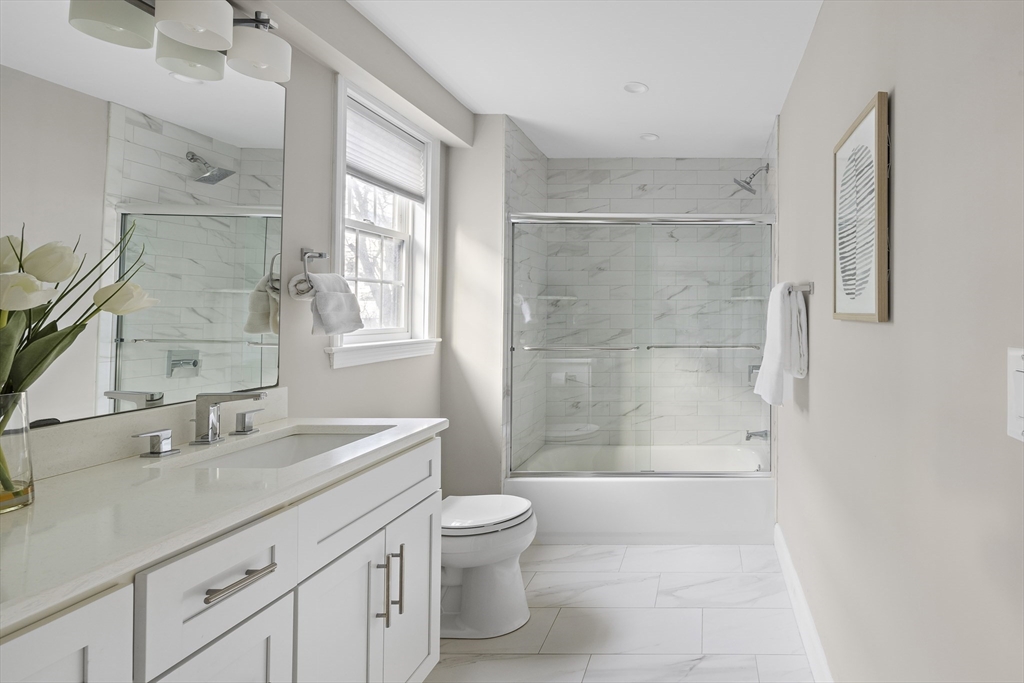12 Madison Street, Unit 2 Somerville, MA 02143 - Photo 9 of 24 a bathroom with a shower sink vanity mirror and toilet