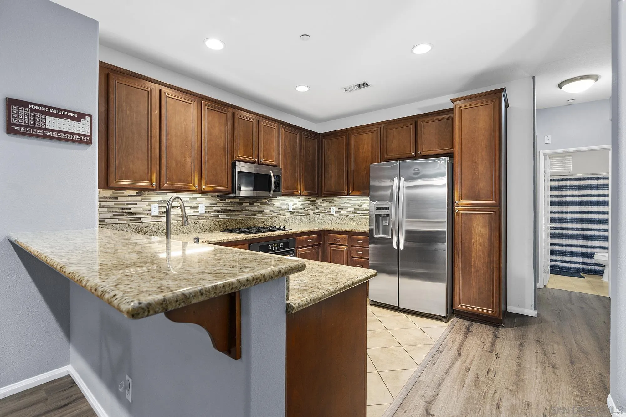 156 Via Montisi Santee, CA 92071 - Photo 13 of 25 a kitchen with a refrigerator sink and cabinets