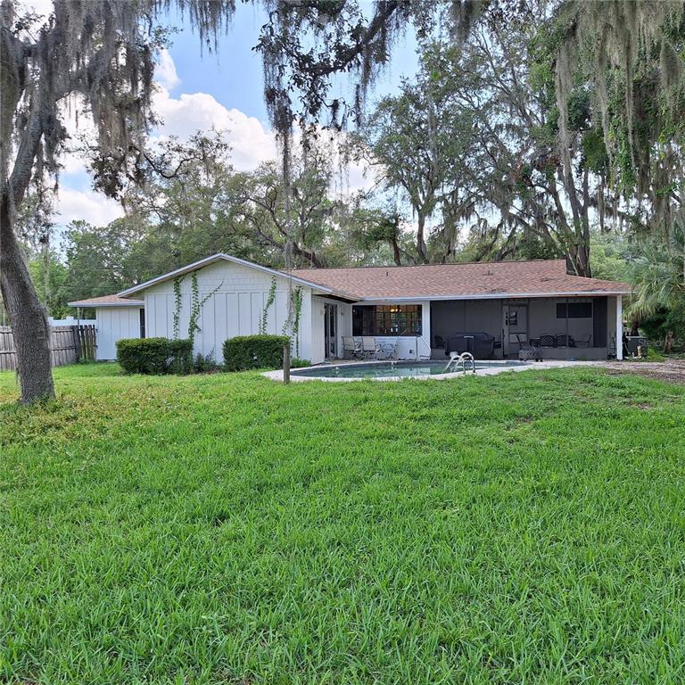 10012 Lake Louisa Road Clermont, FL 34711 - Photo 13 of 25 a front view of a house with a yard and trees