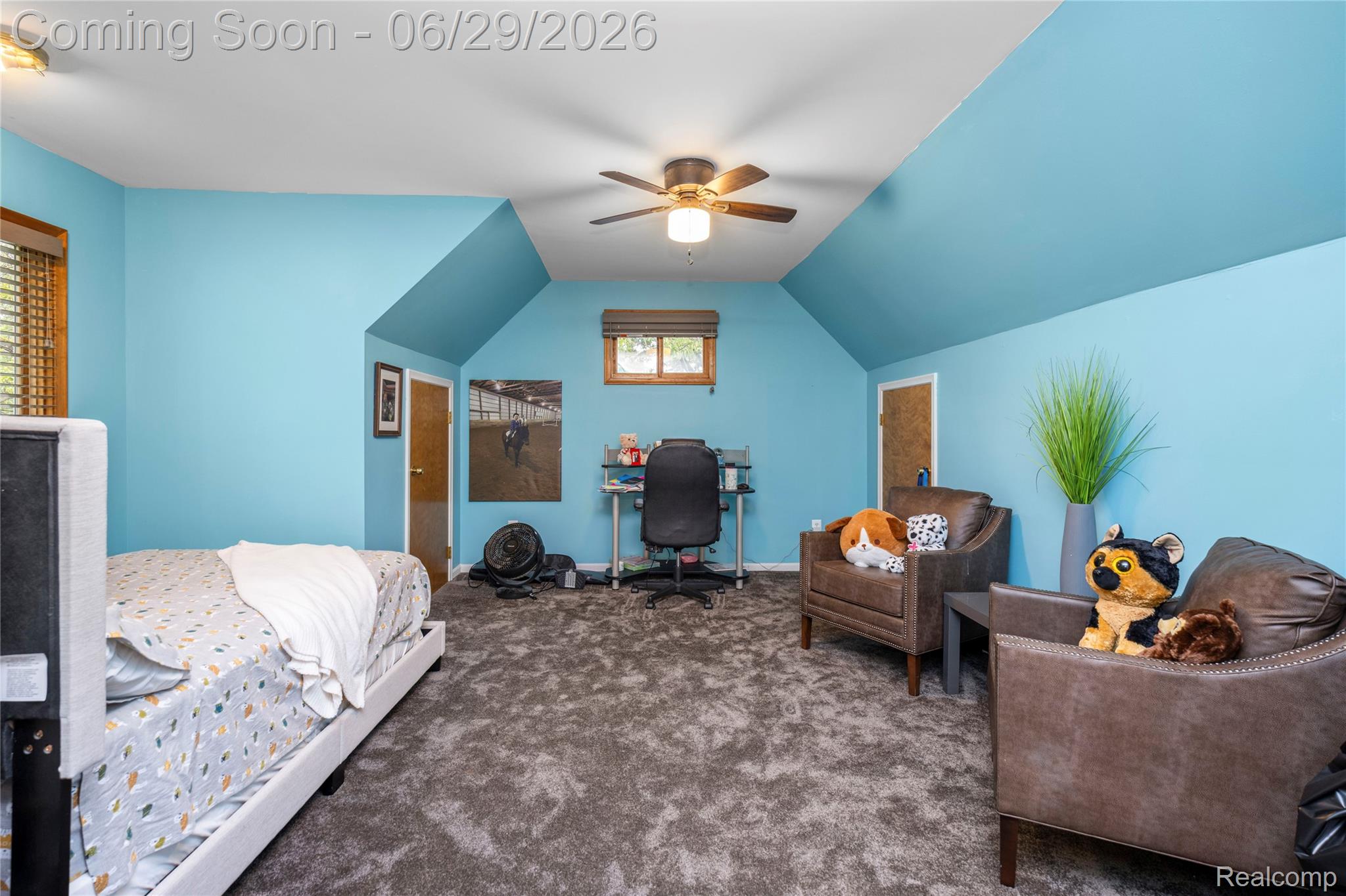 6085 Worlington Road Bloomfield Hills, MI 48301 - Photo 49 of 75 Spacious room featuring vaulted ceilings, a ceiling fan with integrated lighting, two windows with wood-finish blinds, and textured gray carpeting
