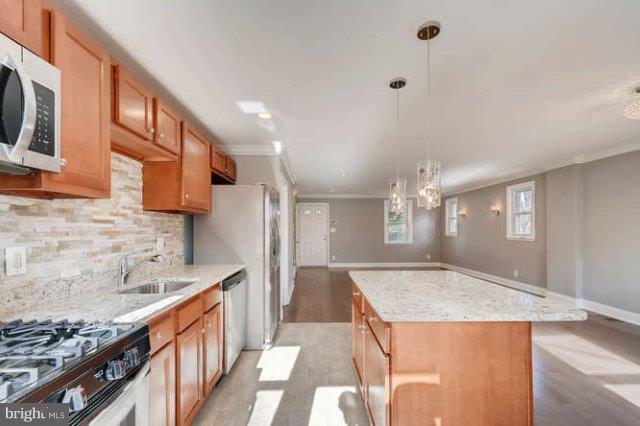4621 Rokeby Road Baltimore, MD 21229 - Photo 2 of 28 a kitchen with stainless steel appliances granite countertop a sink and a stove