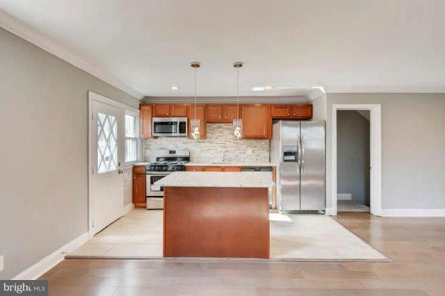 4621 Rokeby Road Baltimore, MD 21229 - Photo 11 of 28 a kitchen with stainless steel appliances granite countertop a refrigerator and a stove