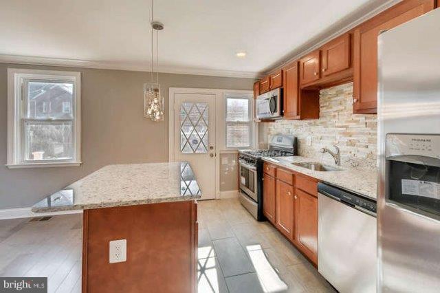4621 Rokeby Road Baltimore, MD 21229 - Photo 12 of 28 a kitchen with stainless steel appliances granite countertop a sink stove and refrigerator
