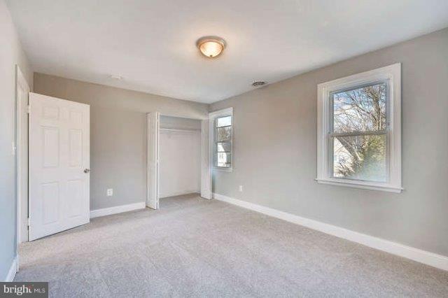 4621 Rokeby Road Baltimore, MD 21229 - Photo 13 of 28 a view of an empty room with windows and closet