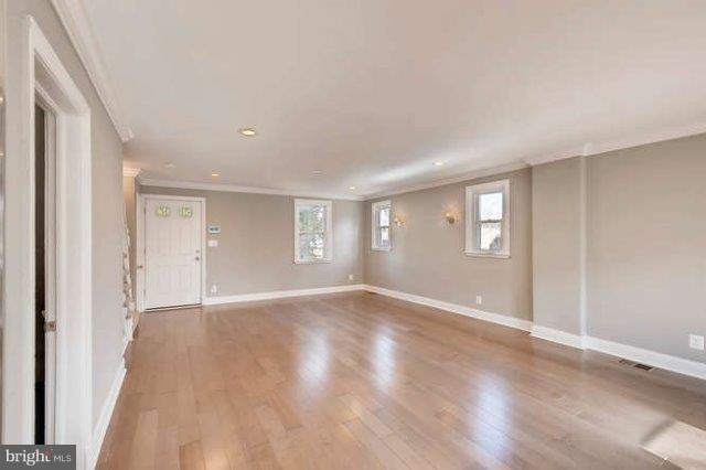 4621 Rokeby Road Baltimore, MD 21229 - Photo 9 of 28 a view of an empty room with wooden floor and window